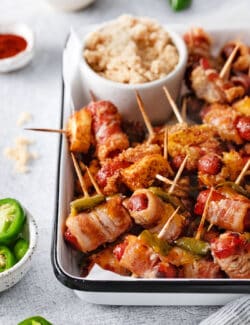 Close-up of bacon wrapped smokies on a serving dish