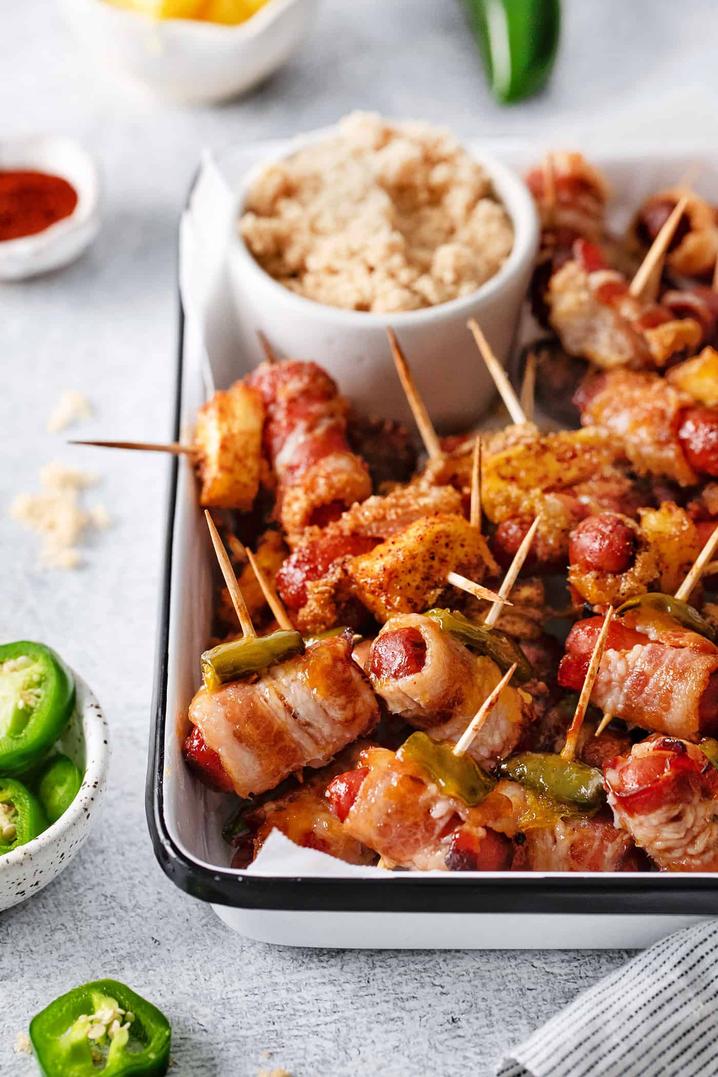 Close-up of bacon wrapped smokies on a serving dish