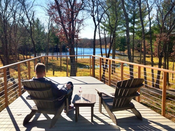 a man sitting on a deck at Canoe Bay 