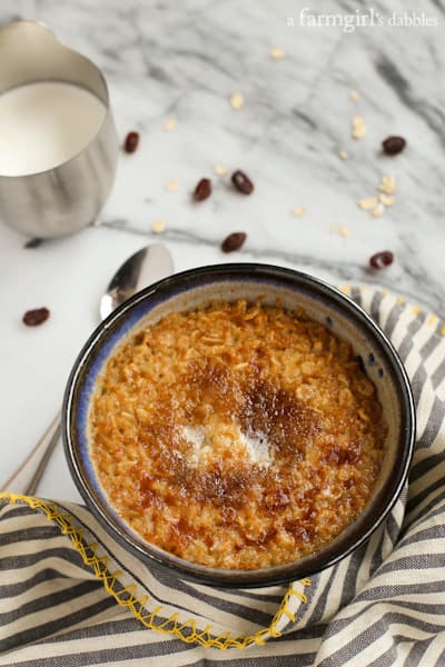 a bowl of Baked Oatmeal with half and half drizzled over