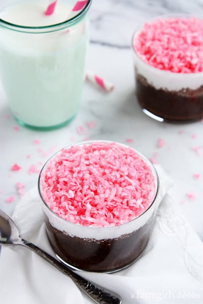two glass cups with Sno Ball Chocolate Cake and a glass of milk