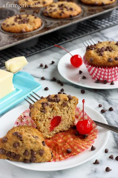 Whole Wheat Banana Muffins in a muffin pan with one muffin cut in half