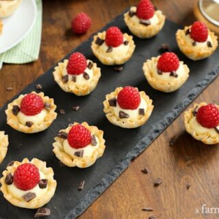 Mini Phyllo Cups filled with Coconut Cream and dark chocolate then topped with a raspberry