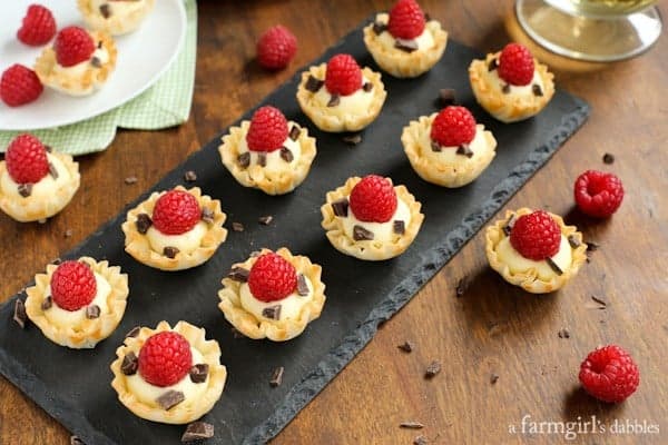 Mini Phyllo Cups filled with Coconut Cream and dark chocolate then topped with a raspberry