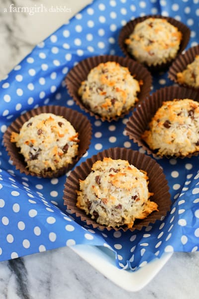 a blue basket of German Chocolate Macaroons in paper cups