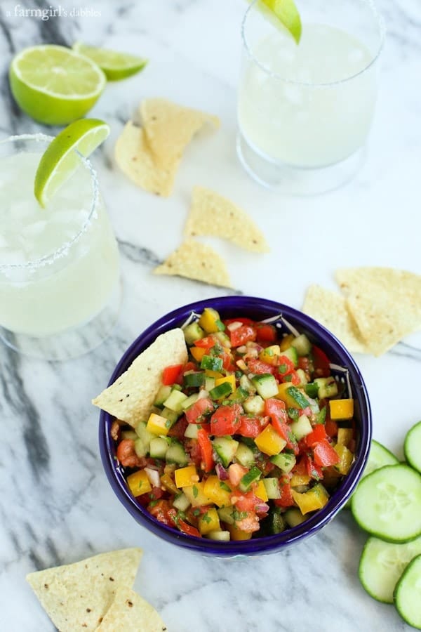 a bowl of Cucumber Pico de Gallo with tortilla chips and margaritas