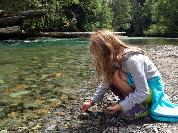 a girl playing in a stream