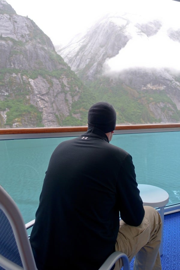 a man sitting on a balcony