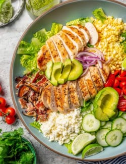 Overhead view of grilled chicken salad on platter
