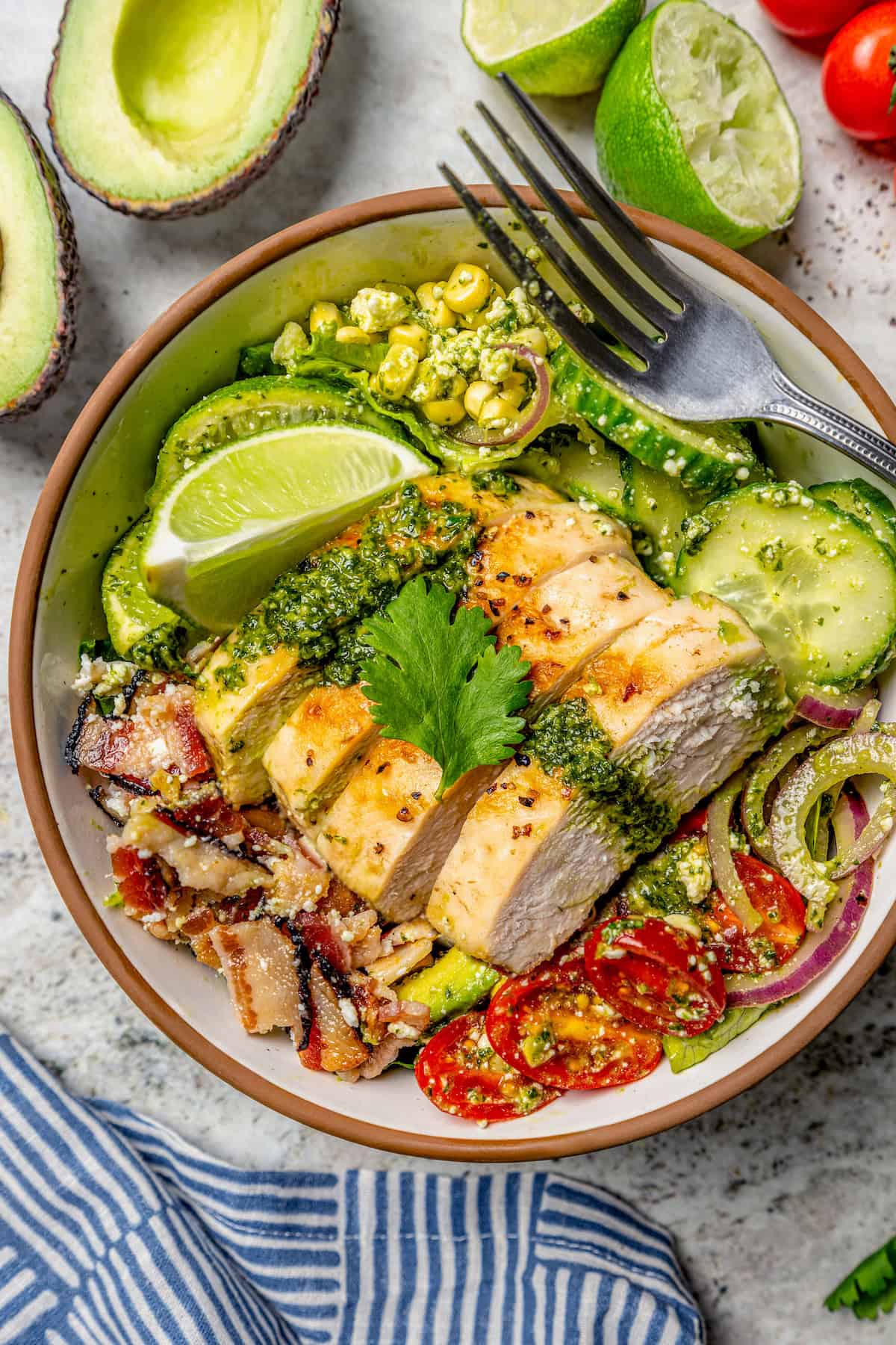Grilled chicken salad in bowl topped with cilantro lime vinaigrette