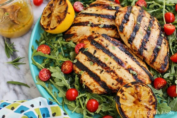 Grilled Chicken Breast Salad with a jar of lemon vinaigrette