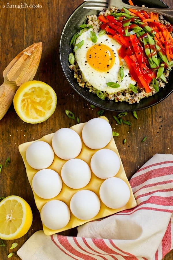 a tray of eggs with a bowl of quinoa