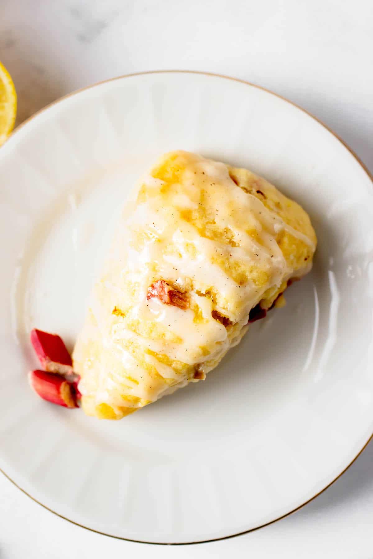 Overhead view of a lemon rhubarb scone on a plate