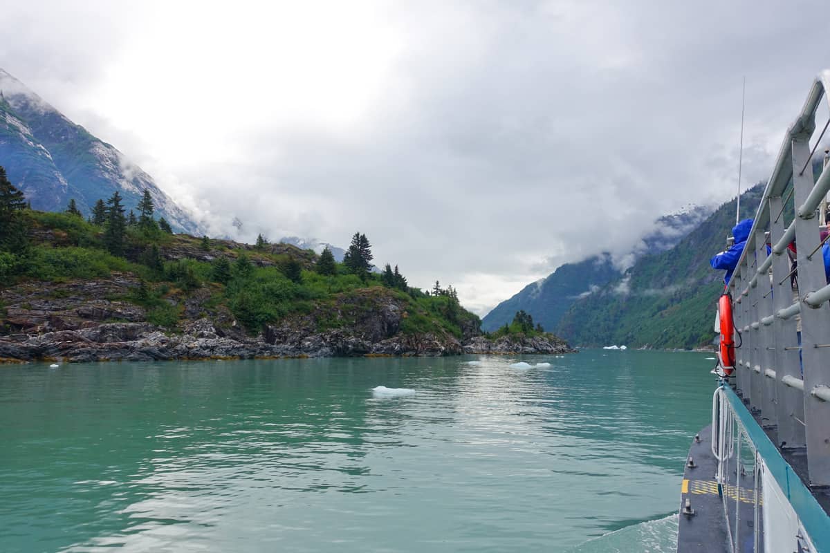 a boat traveling through Tracy Arm Fjord