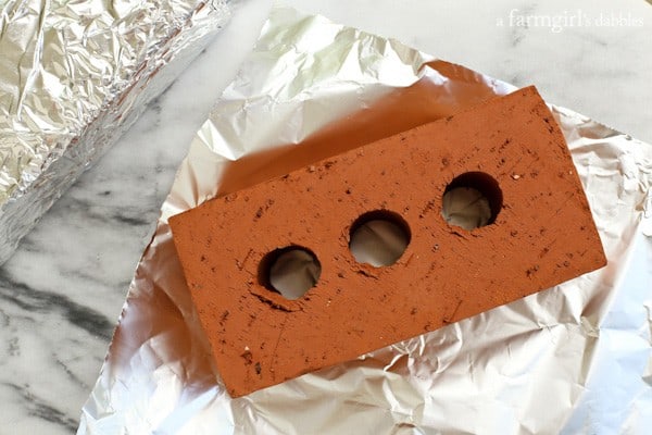 a brick on top of chicken breasts