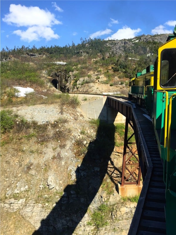 a green and yellow train on White Pass & Yukon Route Railroad