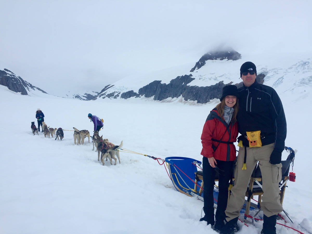 a man and women with a dog sled team