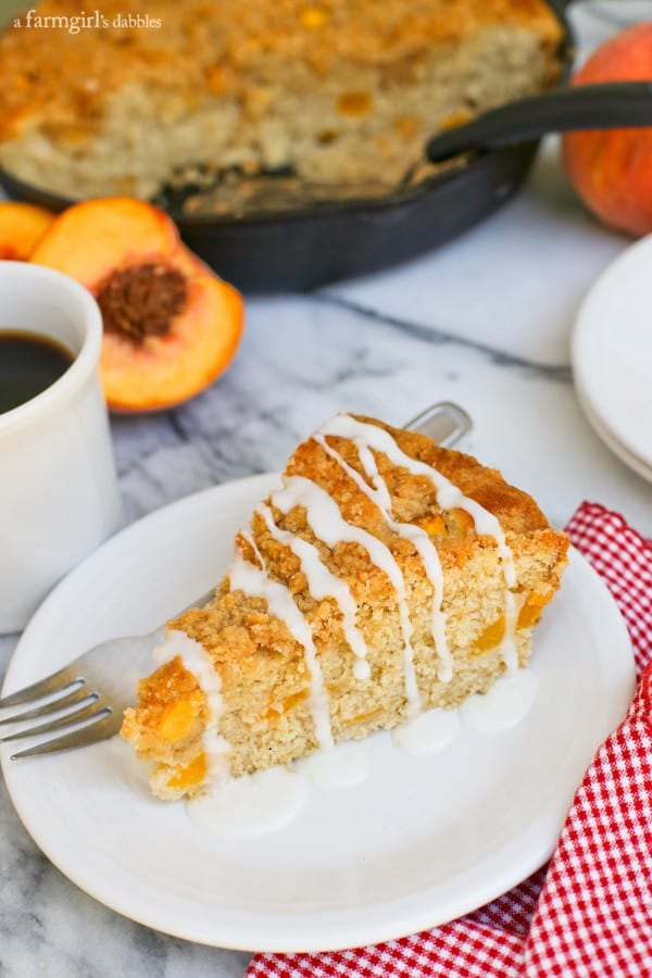 a Peach Coffee Cake slice taken from a skillet