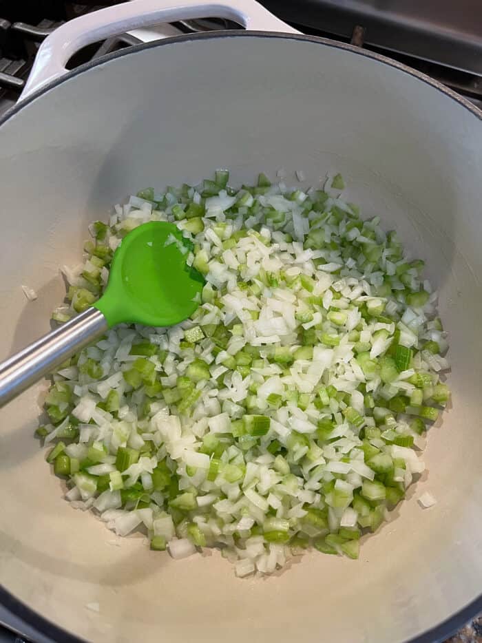 Scallions and garlic being sauteed in a bowl