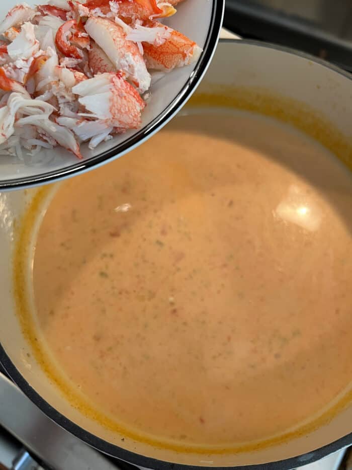 Crab being added to a bisque