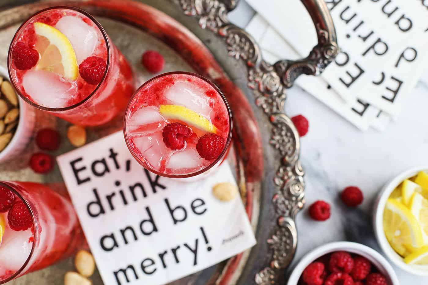 Two raspberry cocktails on a tray