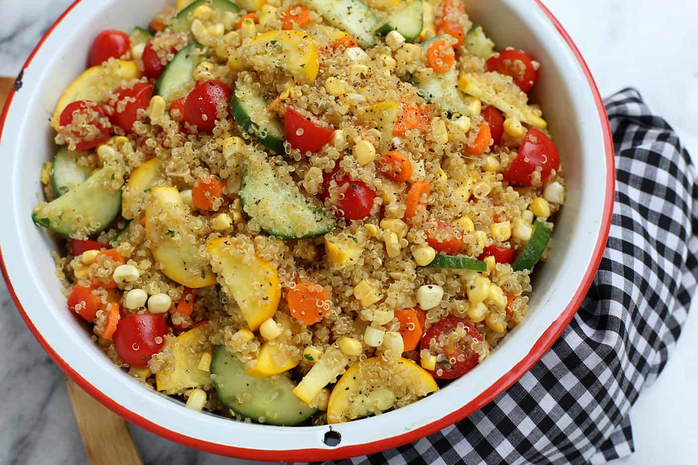 A big red dish of end of summer quinoa salad