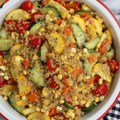 A bowl of quinoa salad with summer vegetables