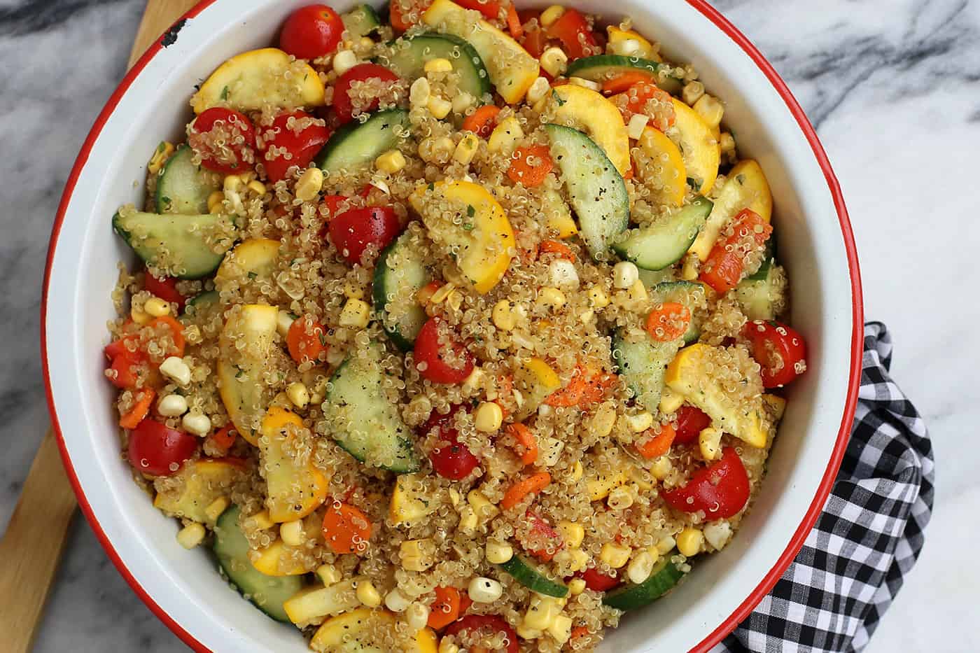 A bowl of quinoa salad with summer vegetables