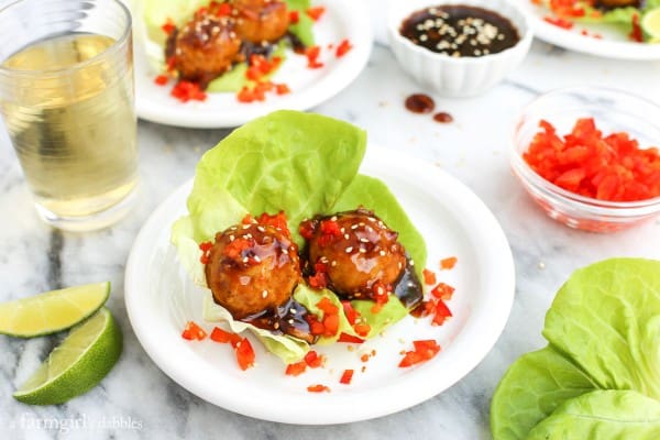 oyster Chicken Meatballs with lettuce and a glass of white wine