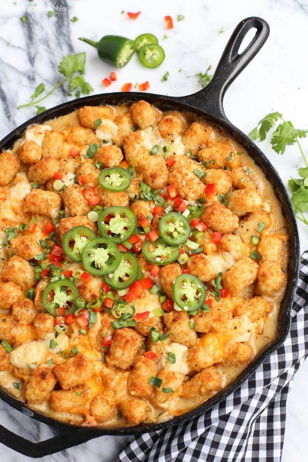 tater tot hotdish with jalapeños in a cast iron skillet