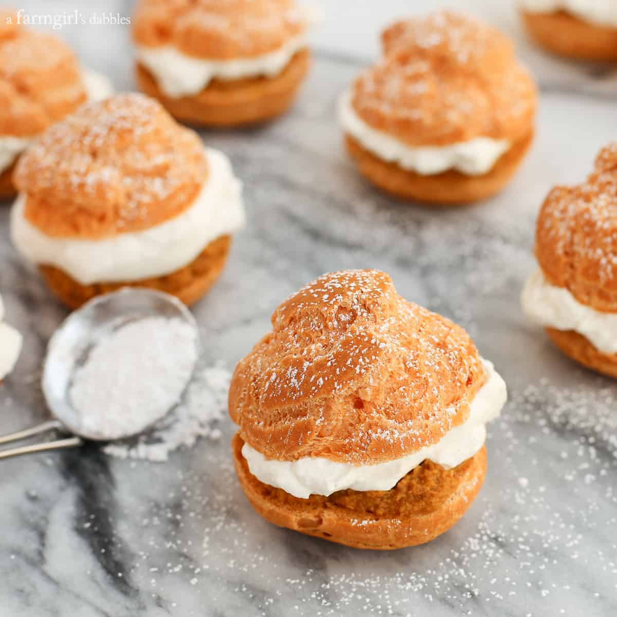 Pumpkin Pie Cream Puffs dusted with powdered sugar.