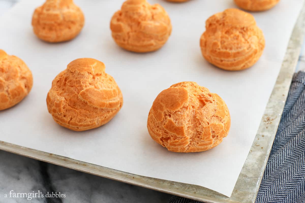 Fresh baked Cream Puffs on a baking sheet.