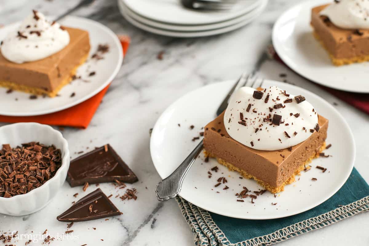 French Silk Pie Bars with whipped cream and chocolate shavings