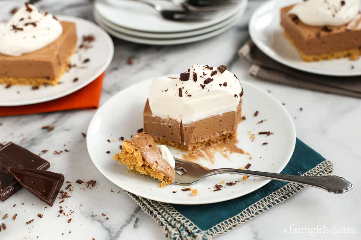 a slice Chocolate French Silk Pie Bars with a bite taken out