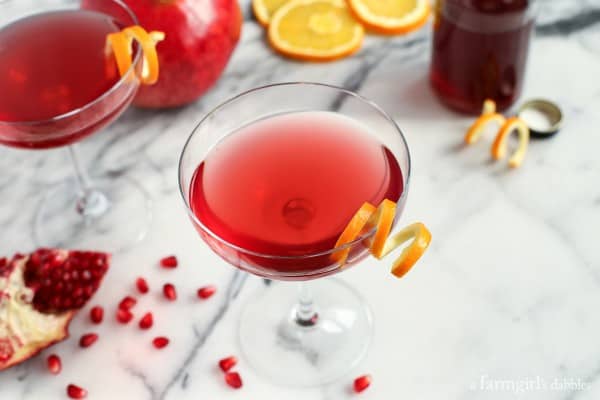 cocktail glasses of Cosmos with fresh pomegranate seeds