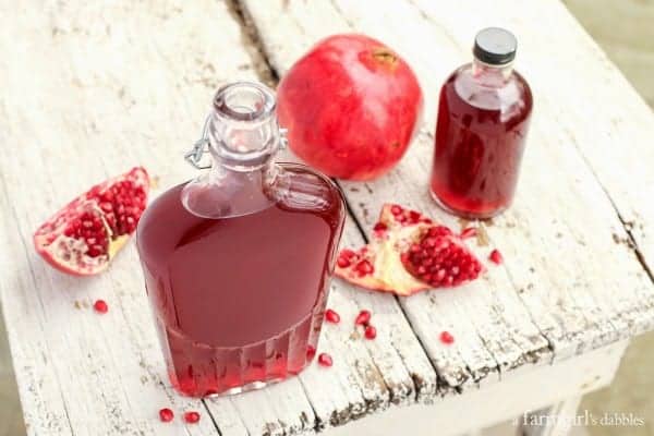 Pomegranate Shrub mixture in a bottle on a wood table