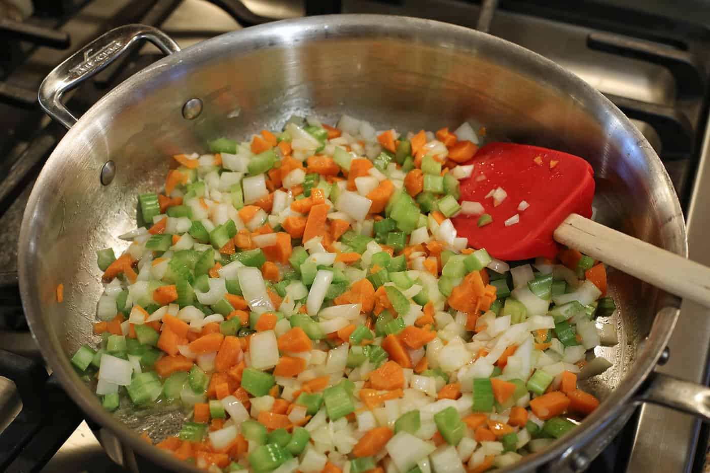Carrots, celery and onion being sauteed