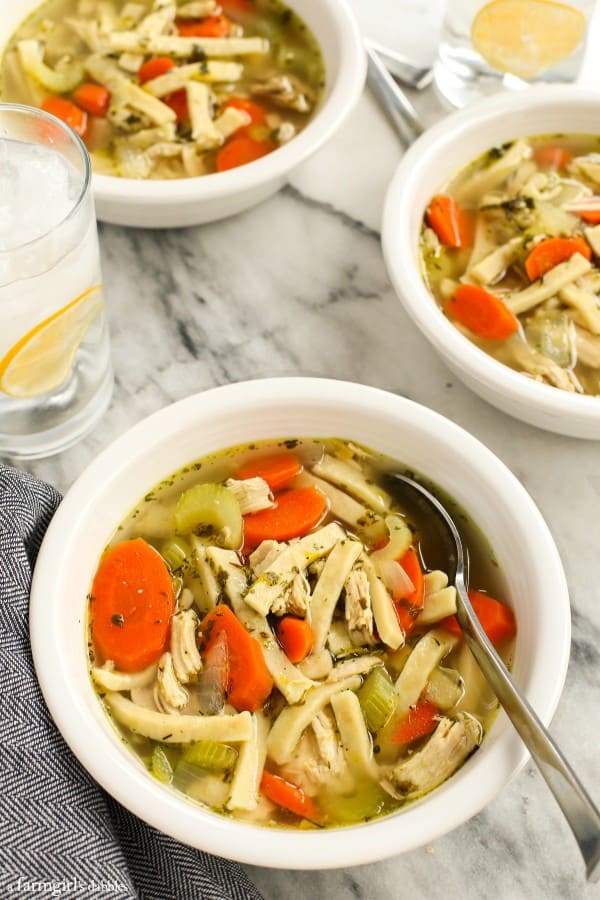 Classic chicken noodle soup in a white bowl with a spoon