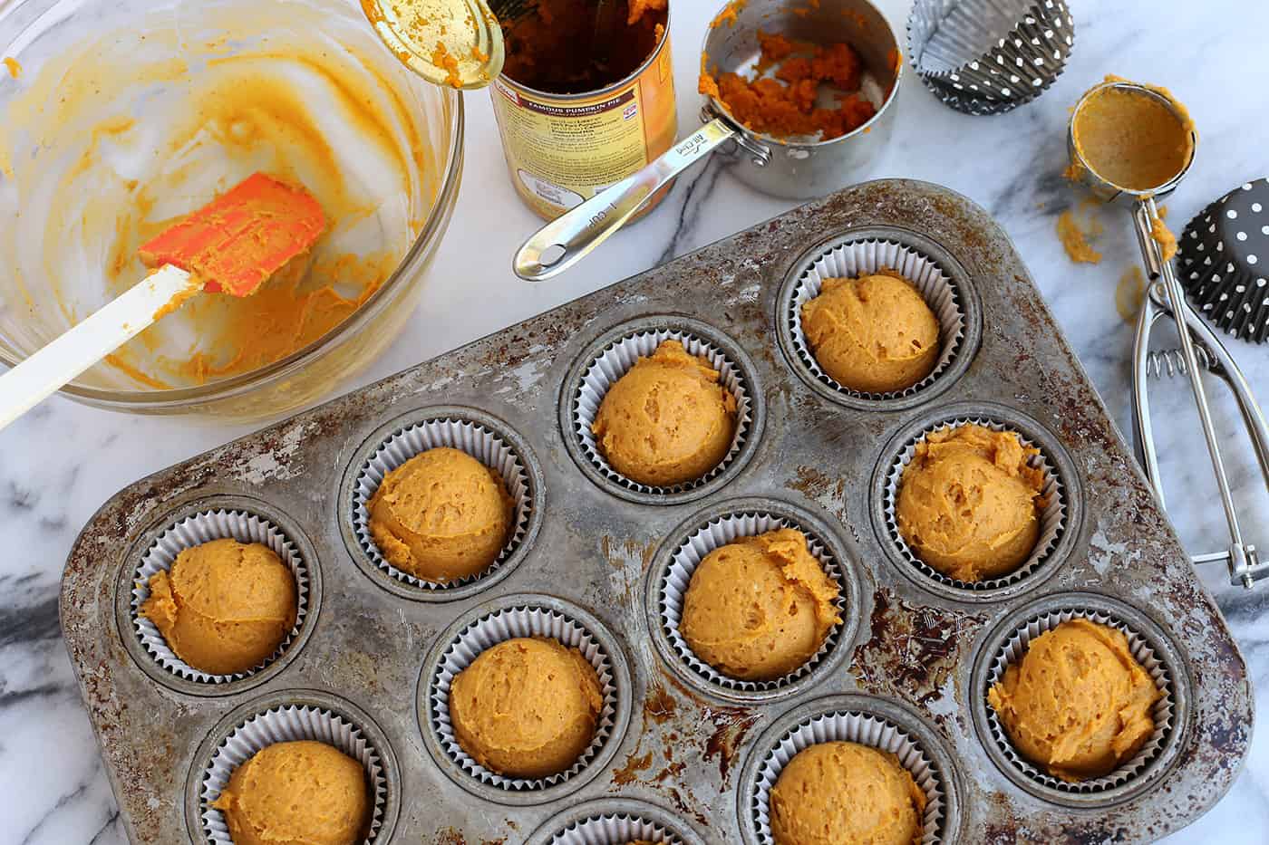 Pumpkin muffin batter in a muffin tray