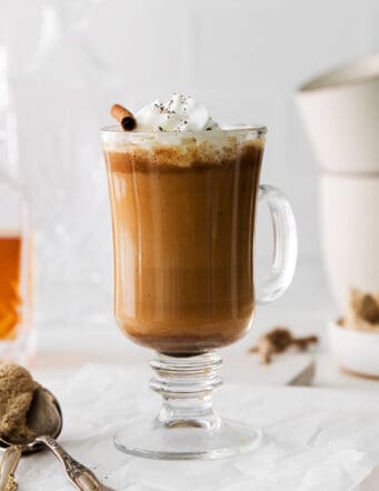 A hot buttered rum coffee garnished with whipped cream