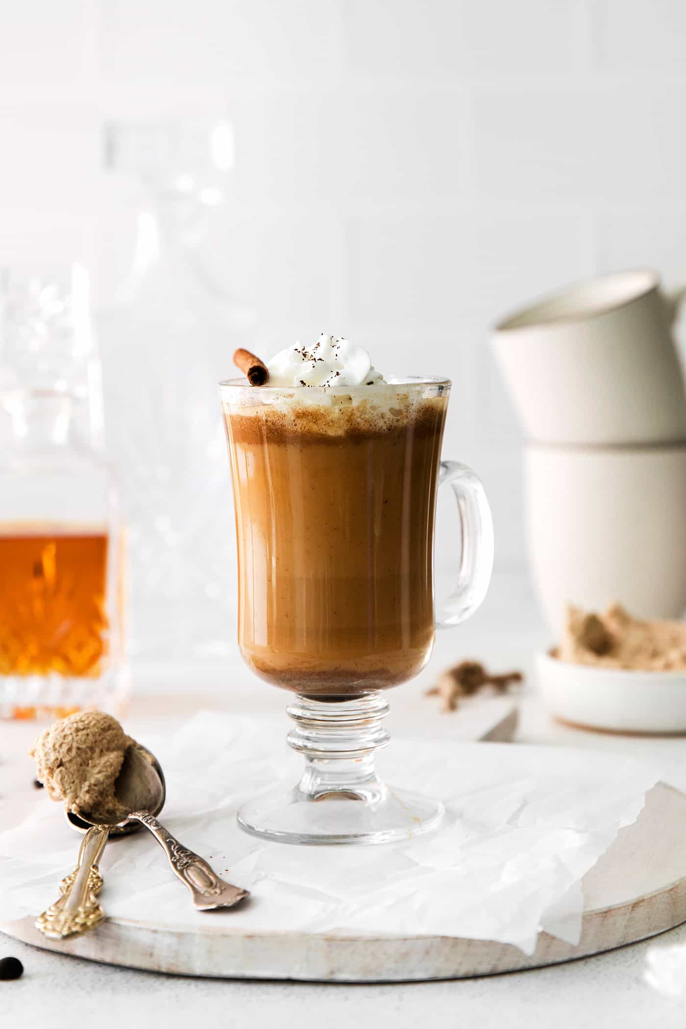 A hot buttered rum coffee garnished with whipped cream