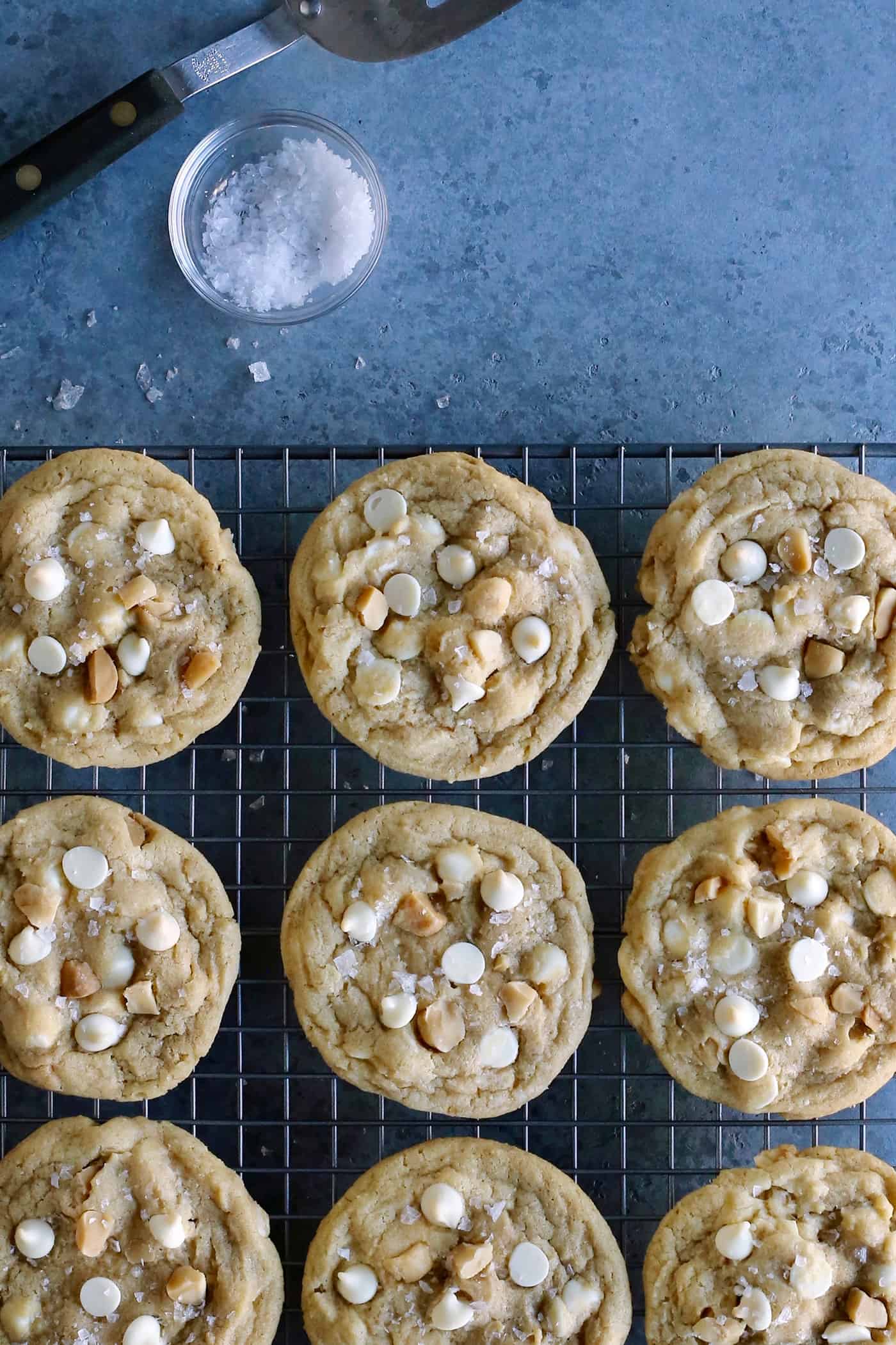 Overhead view of white chocolate macadamia nut cookies on a cooling rack