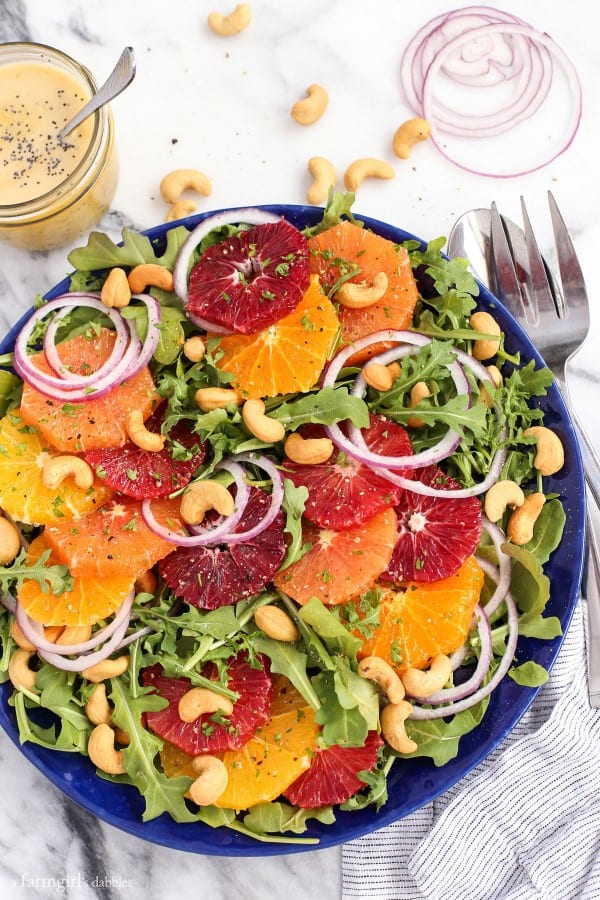 lettuce with orange slices, cashews, and red onion