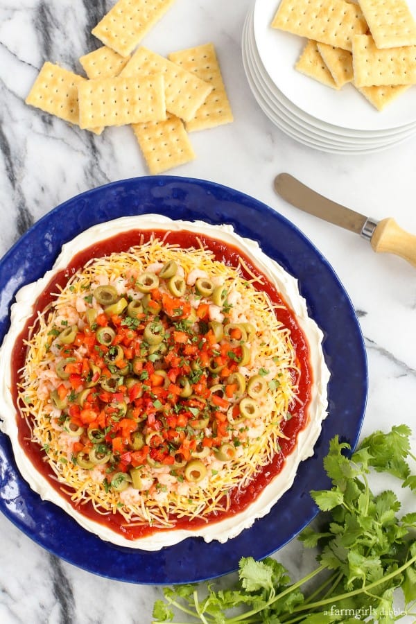 Chili Shrimp Dip on a blue plate with club crackers