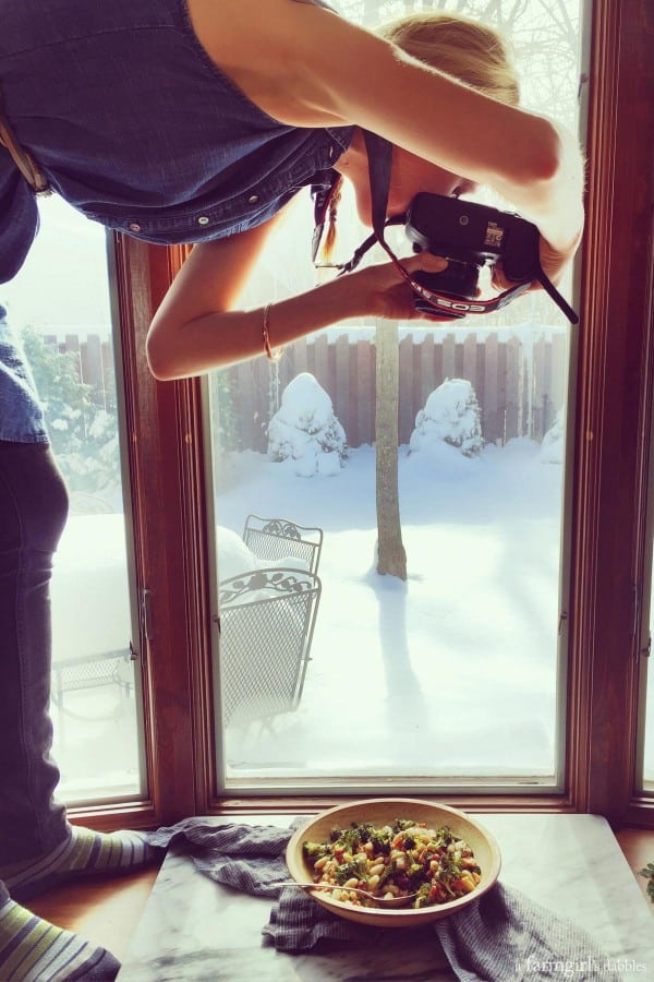 photo of woman photographing the finished dish