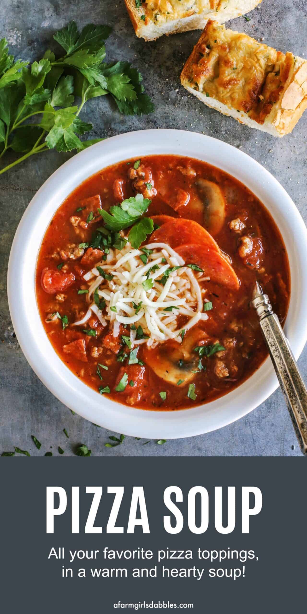 pinterest image of a bowl of cheesy pizza soup with homemade garlic cheesy bread