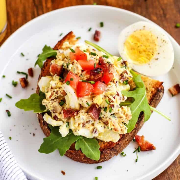 egg salad on toast, on a white plate