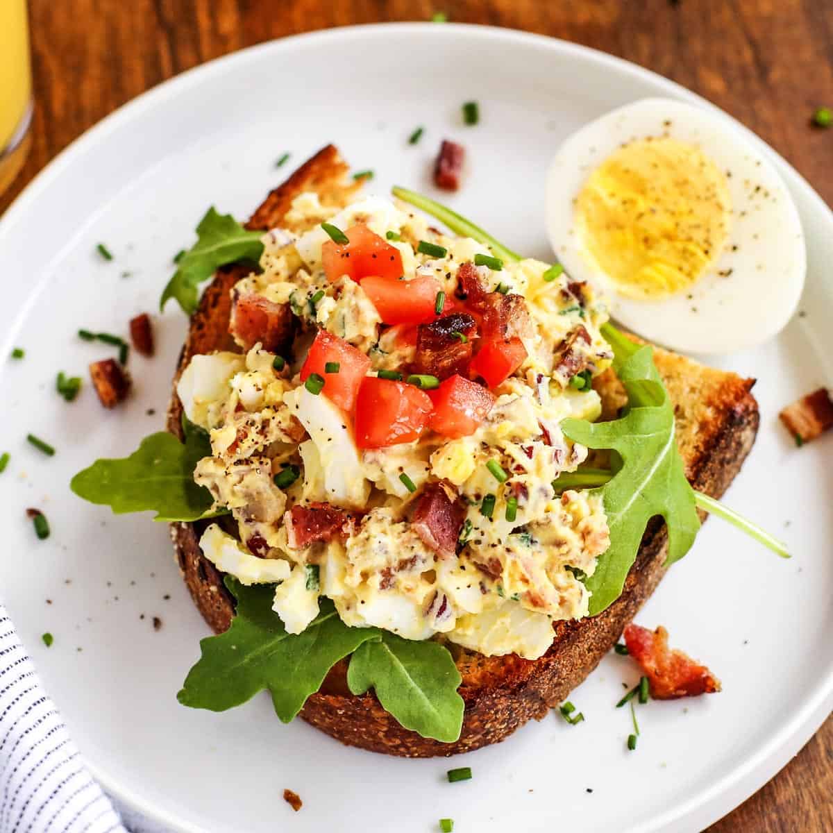 egg salad on toast, on a white plate