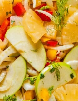 Closeup view of fennel apple salad with pineapple and bell peppers.