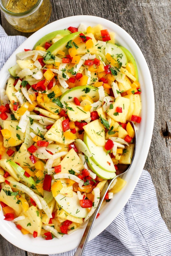 Green Apple, Pineapple, and Fennel Salad with Honey Ginger Dressing in a large white dish